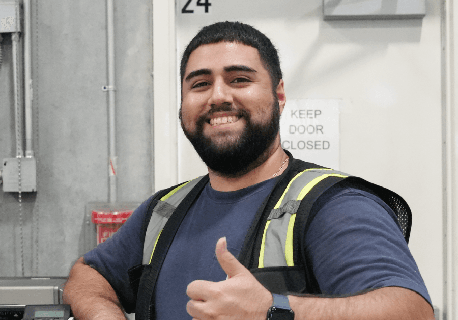 Employee in blue shirt giving thumbs up